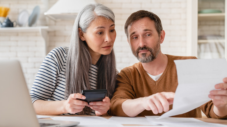 Two people looking at paperwork 