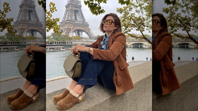 Girl wearing clogs with flared denim.