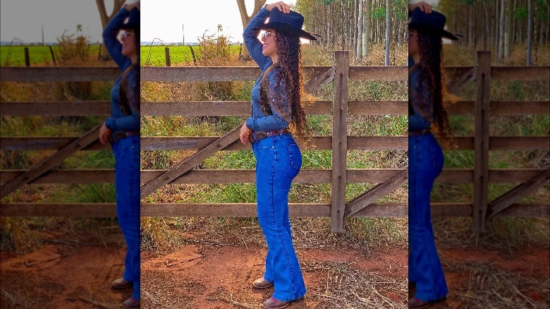 Girl wearing flared denim and cowgirl boots.