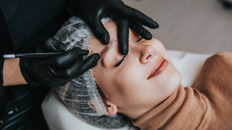 young woman getting microbladed
