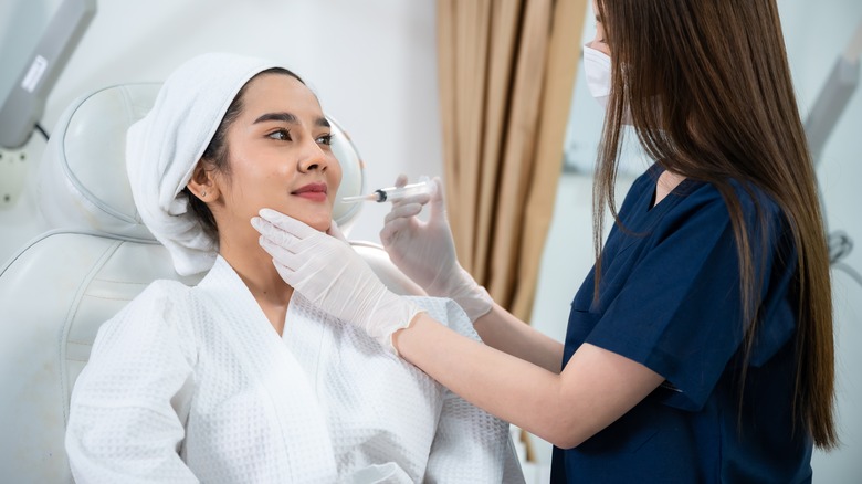 young asian woman getting botox