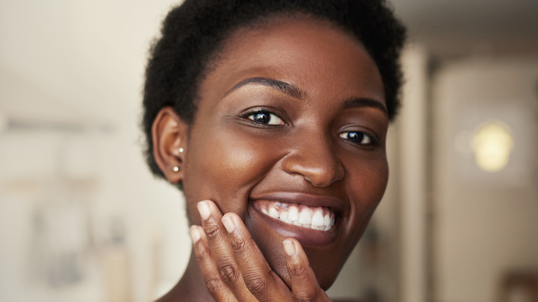Smiling woman with glowing, hydrated skin