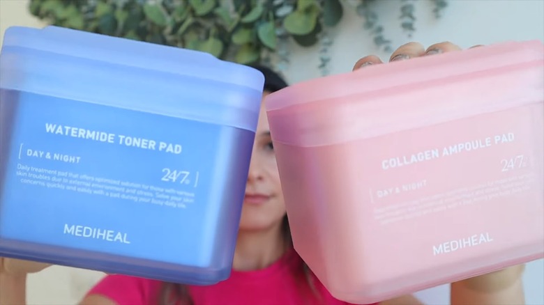 YouTuber holds up Korean toner pad containers 