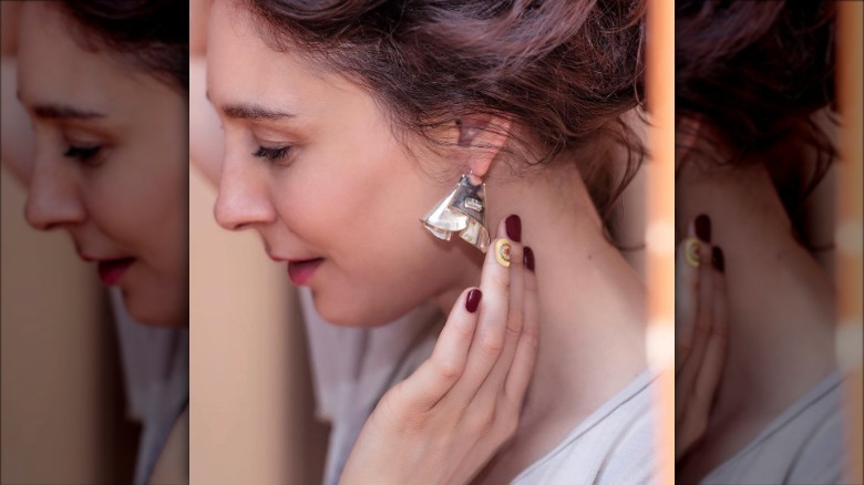 woman wearing melted silver earrings