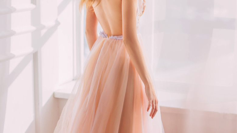 Woman in pastel pink dress