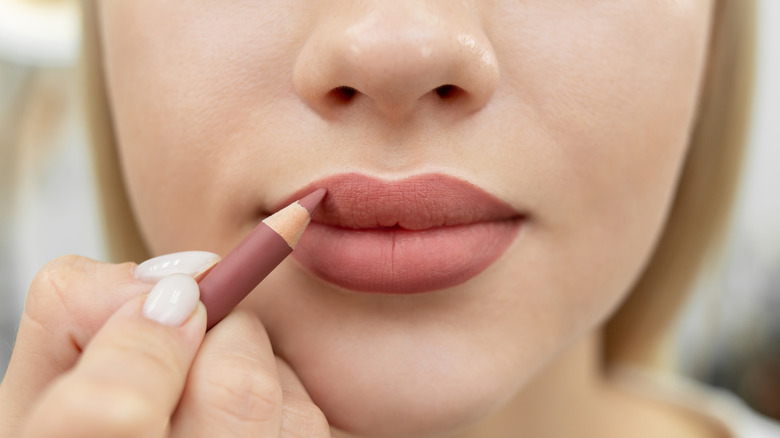 woman applying lip liner 