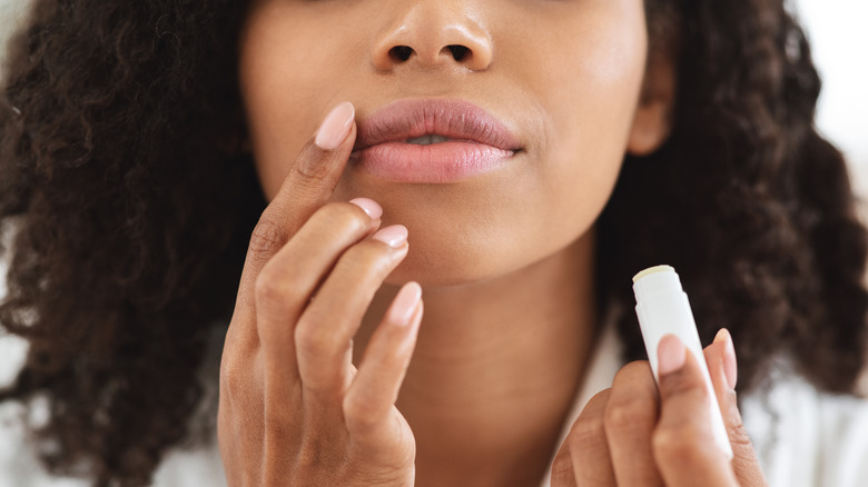 Woman appplying SPF lip balm