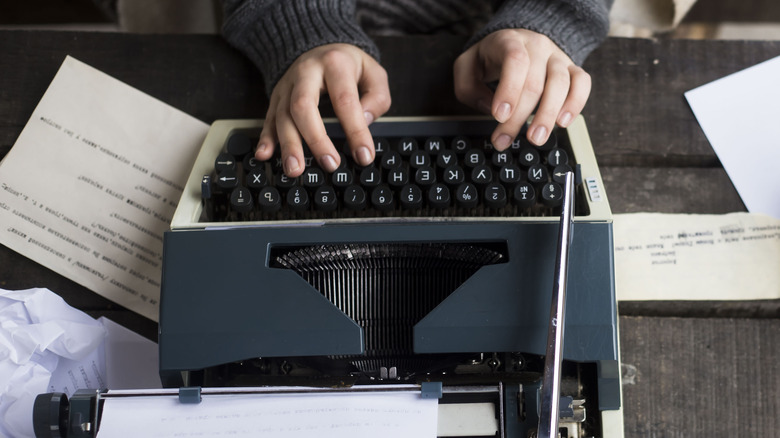 woman writing on typewriter