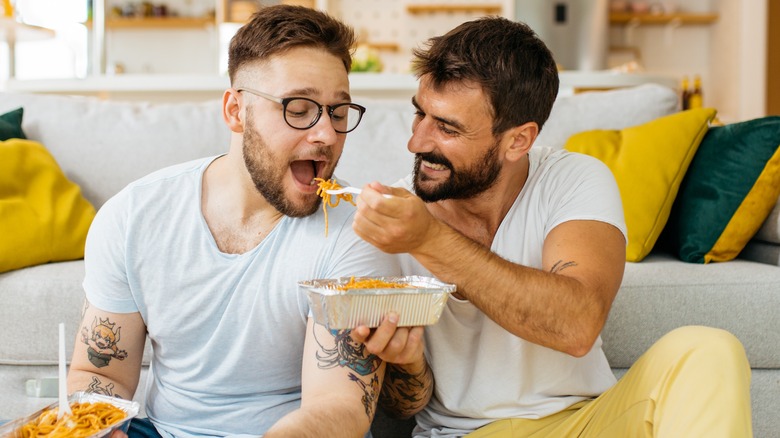 A man feeding partner