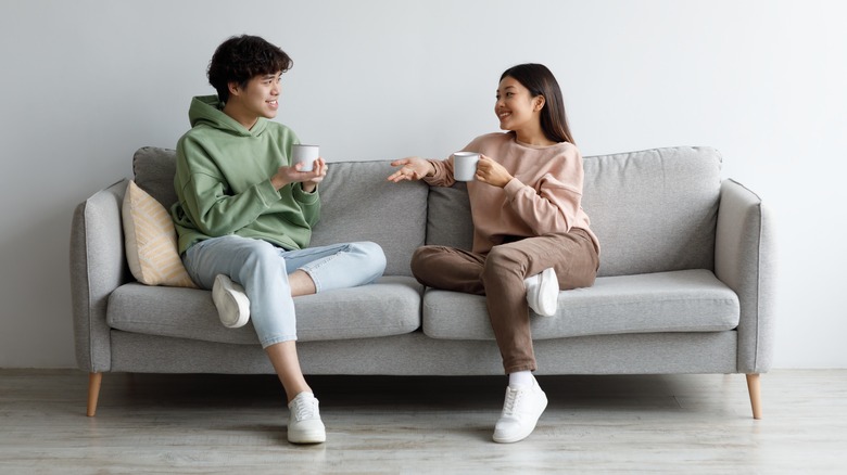 Couple talking on couch