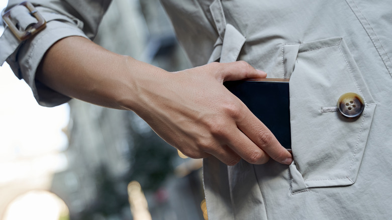 Woman putting phone in pocket