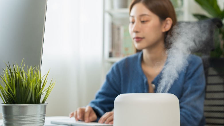 woman sitting near humidifier