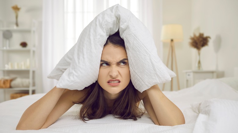 Angry woman holding pillow