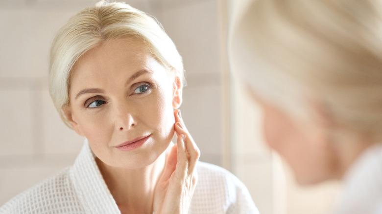 woman looking in mirror