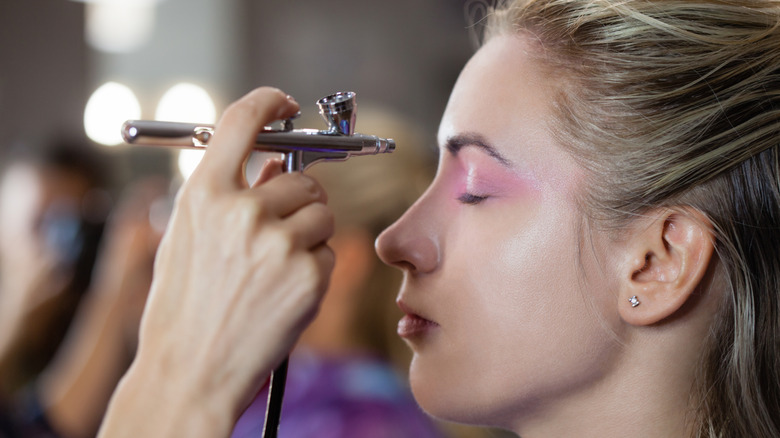 woman getting face sprayed