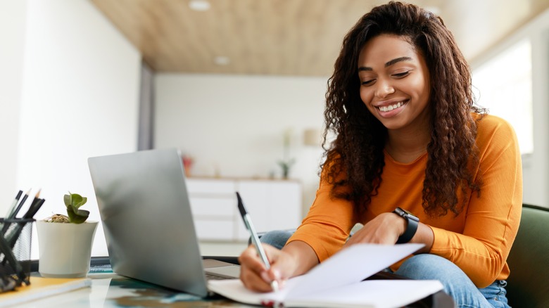 Woman smiling while using computer