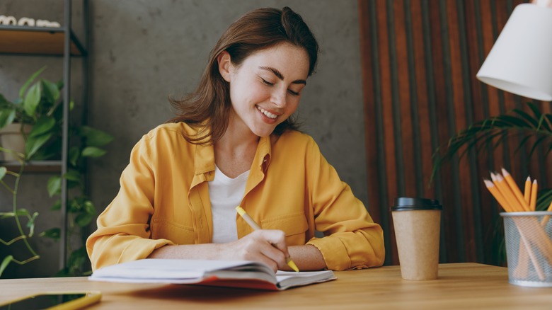 Woman writing in a notebook