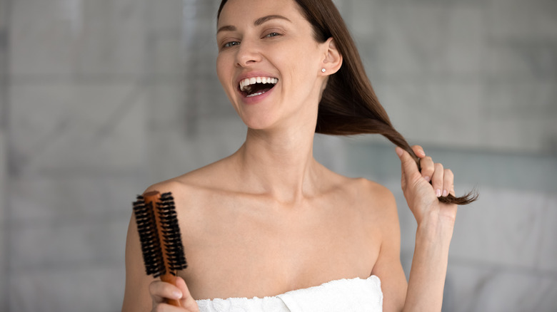 Woman using boar bristle hairbrush
