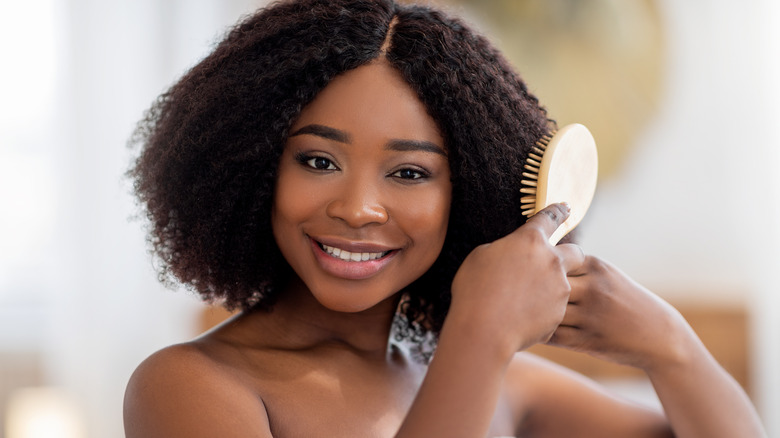 Woman using nylon bristle hairbrush