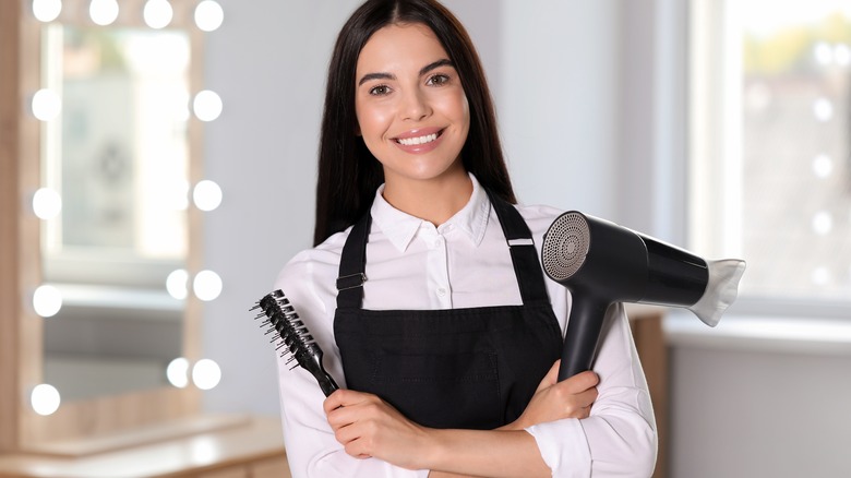 Woman holding vented hairbrush