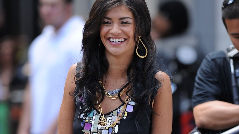 female wearing stacked gold chains