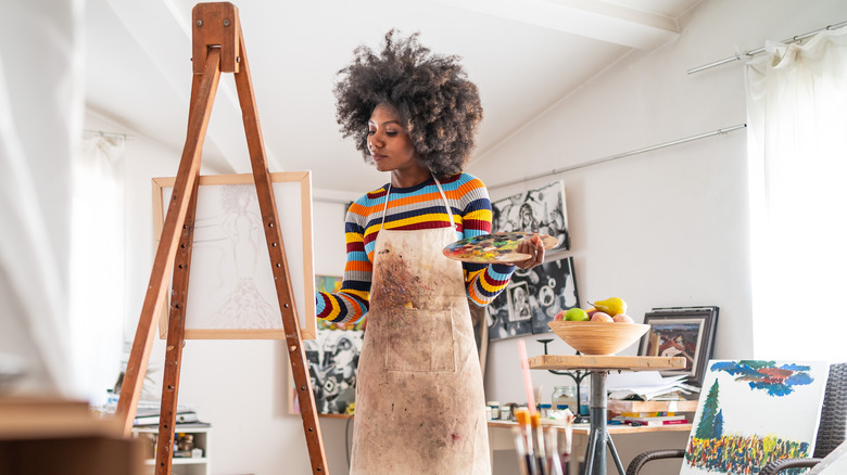 woman painting at easel