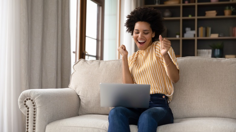 woman cheering at computer