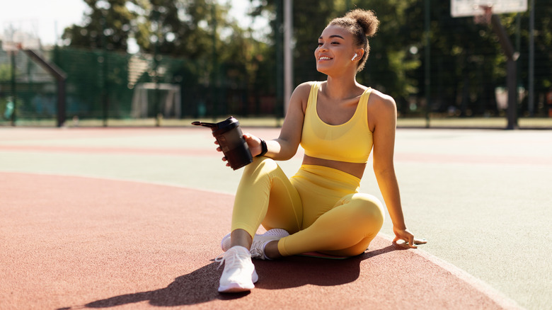 Woman on track with water bottle