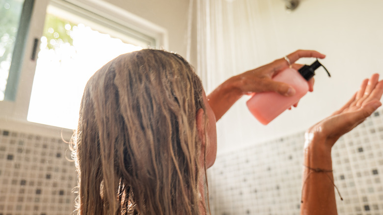 Woman shampooing hair