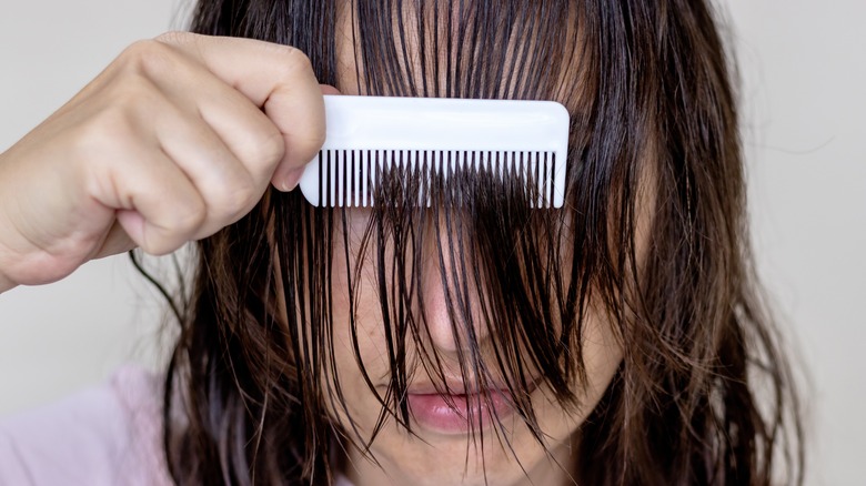 Woman combing wet hair