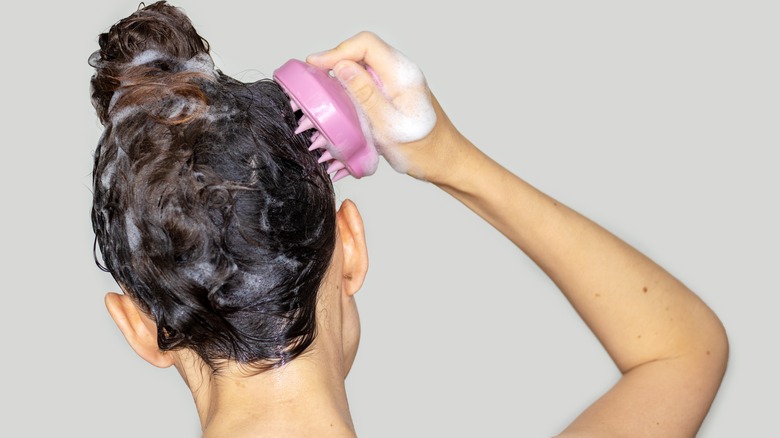 Woman exfoliating scalp