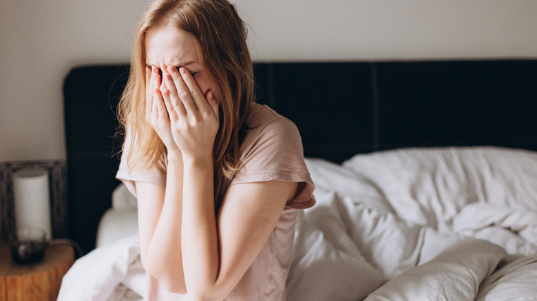 Lonely woman crying in bed 