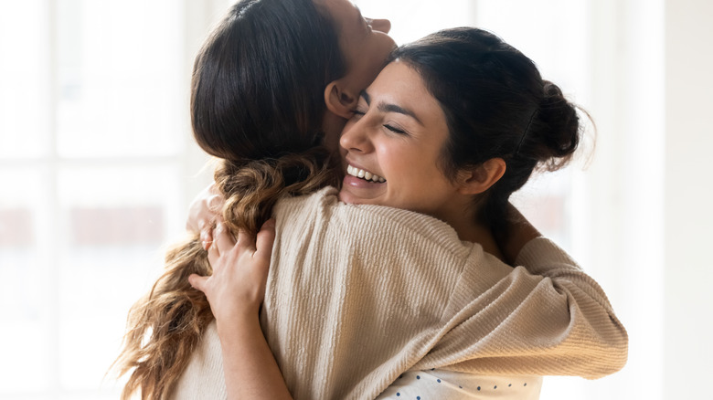 Friends hugging and smiling