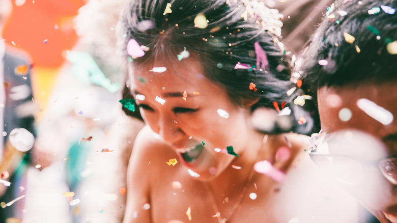 Bride throwing petals 