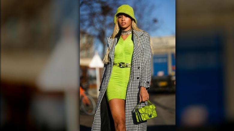 woman wearing a neon green dress and hat