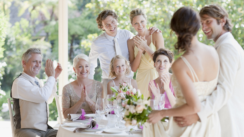 wedding guests clapping at a table
