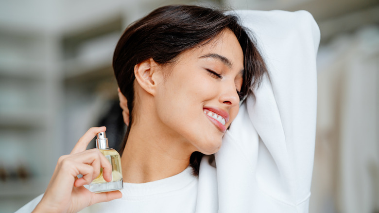 woman spraying perfume 