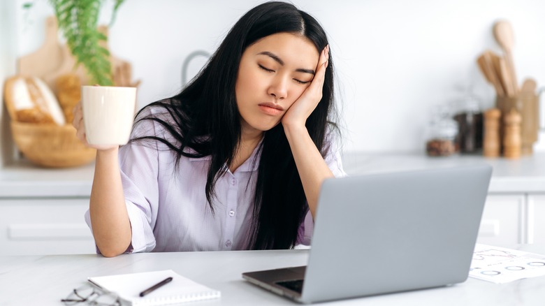 sleepy woman with laptop