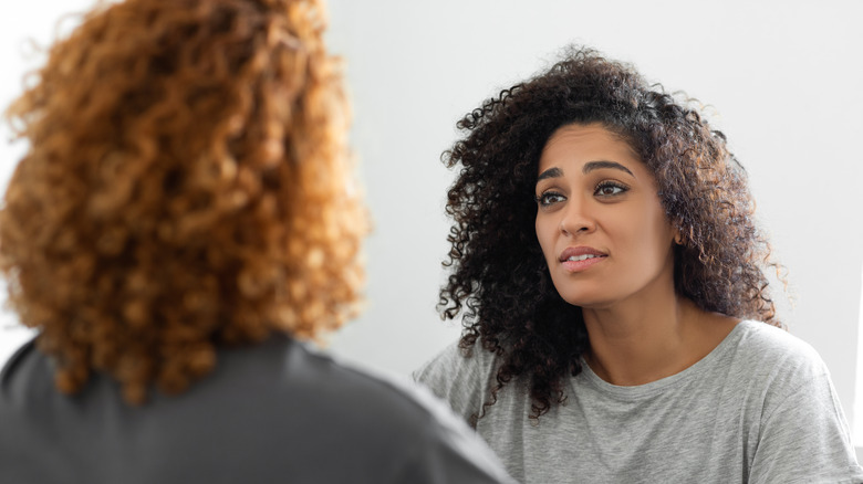 woman having conversation with other woman