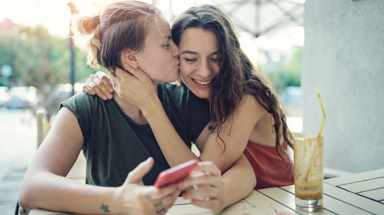 Woman kissing her partner cheek