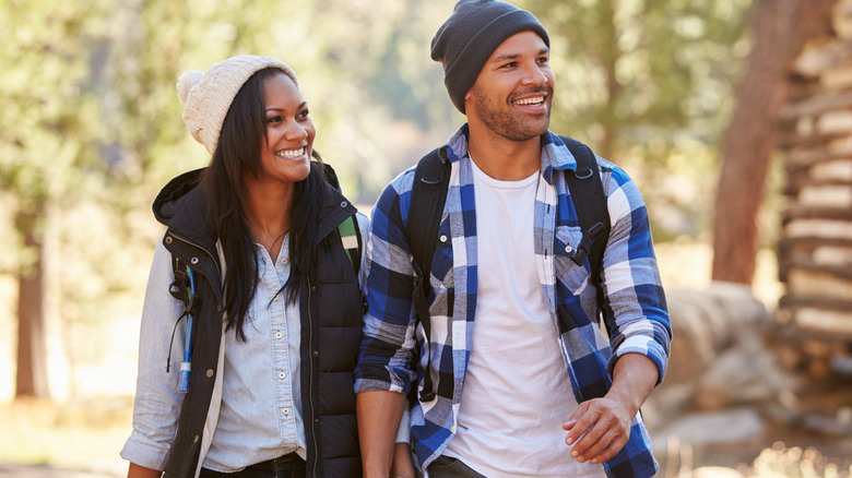 Young couple hiking holding hands